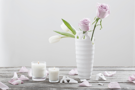 pink roses in broken vase on old wooden tableの写真素材