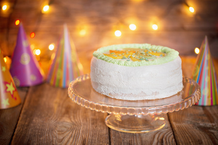 birthday cake on wooden table on light backgroundの写真素材