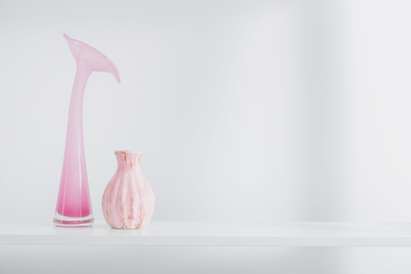 pink vases on white shelfの写真素材