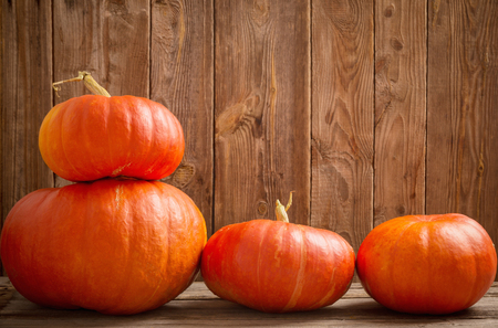 three pumpkins on wooden backgroundの写真素材