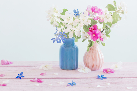 Beautiful ripe apples and branches in vase on whiteの写真素材