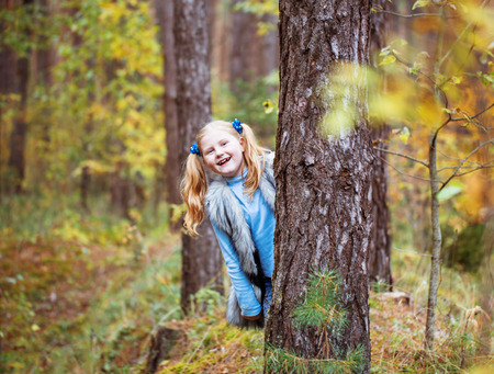 funny girl in autumn parkの写真素材