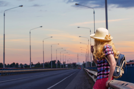 teen girl on road at sunsetの写真素材