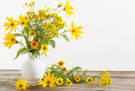 flowers in vase on wooden tableの写真素材