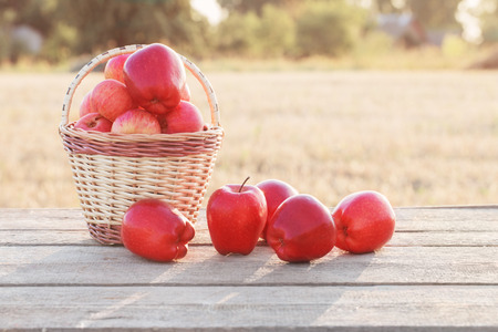 red apples on wooden table outdoorの写真素材