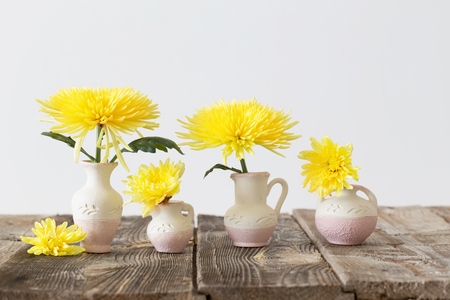 yellow flowers on wooden tableの写真素材