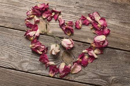 dried rose petals on wooden tableの写真素材