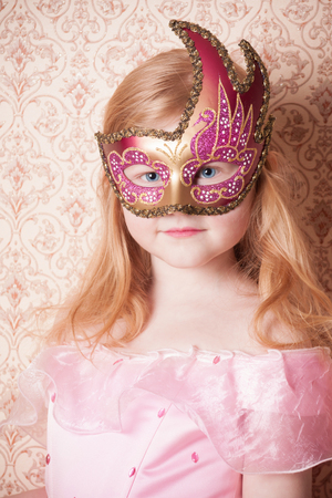 little girl in carnival maskの写真素材