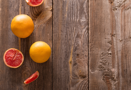 Set of sliced citrus fruits over wooden backgroundの写真素材
