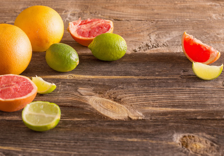 Set of sliced citrus fruits over wooden backgroundの写真素材