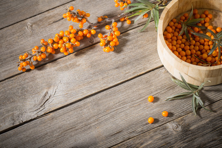 Sea buckthorn berries on a wooden backgroundの写真素材
