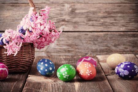 easter eggs in basket on wooden backgroundの写真素材