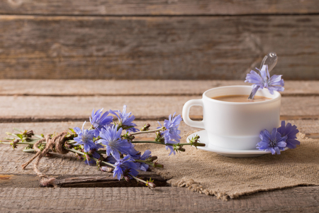 Cup of tea with chicory on wooden backgroundの写真素材