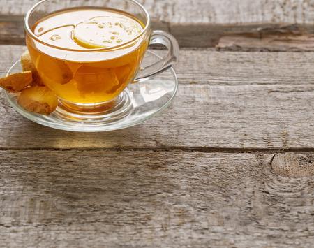 cup of ginger tea on a wooden tableの写真素材