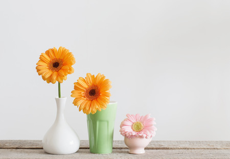 flowers in vases on old wooden tableの写真素材