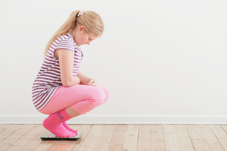 girl on scales indoorの写真素材