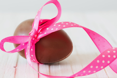 Chocolate Easter egg on wooden backgroundの写真素材