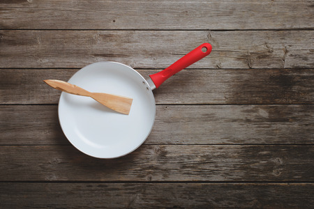 frying pan on old wooden backgroundの写真素材