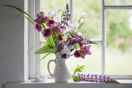Flower vase sitting inside of windowの写真素材