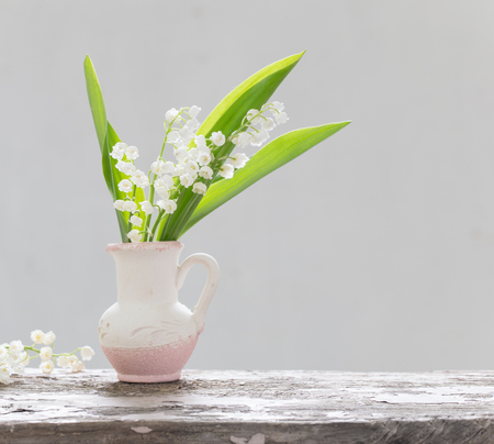 beautiful spring flowers on old wooden tableの写真素材