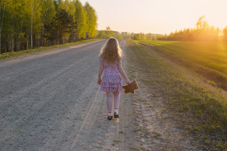 young girl walking awayの写真素材
