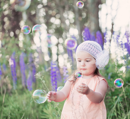 child with soap bubbles outdoorの写真素材