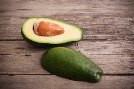 Ripe avocado on a wooden background