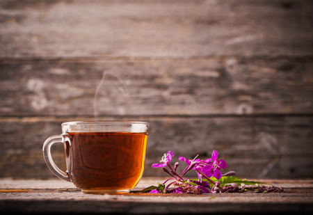 cup of tea with willow-herb on wooden backgroundの写真素材