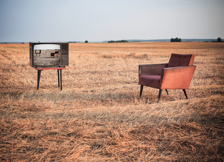 TV and chair in summer fieldの写真素材