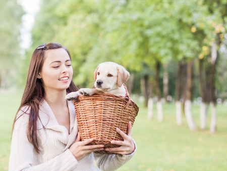 Girl with her dog resting outdoorsの写真素材