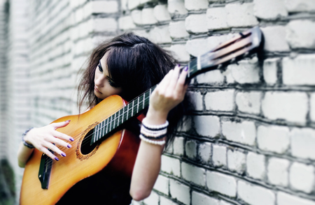 beautiful girl with guitar outdoorの写真素材