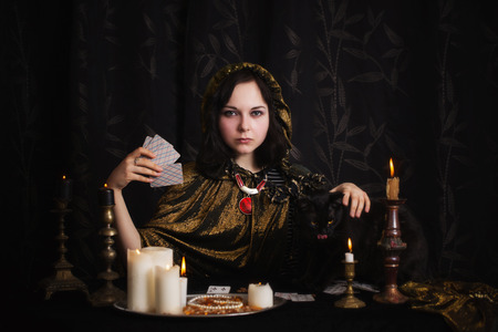 Young woman with divination cards in roomの写真素材