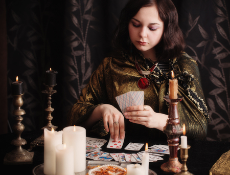 Young woman with divination cards in roomの写真素材