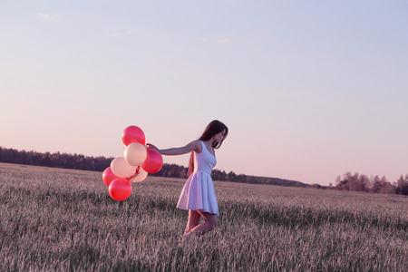 young women with balloons outdoorの写真素材