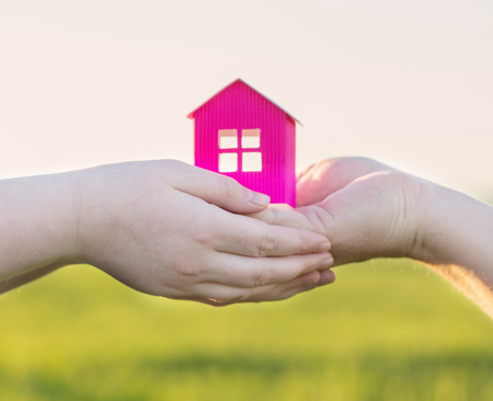 paper house in hand outdoorの写真素材