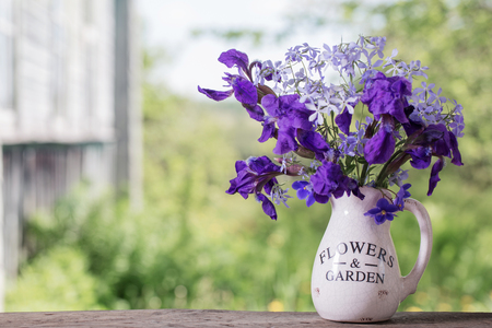beautiful bouquet with irises on wooden tableの写真素材