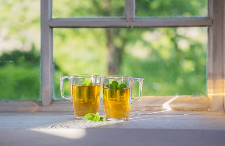tea in glass cup on old  windowsillの写真素材