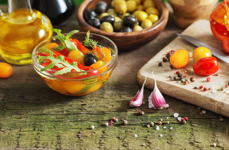 vegetables and olives on old wooden backgroundの写真素材