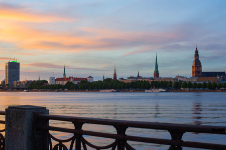 Riga, Latvia - June 18, 2017: Evening view on the embankment of the Daugava River and the spiers of churches in Riga.のeditorial素材