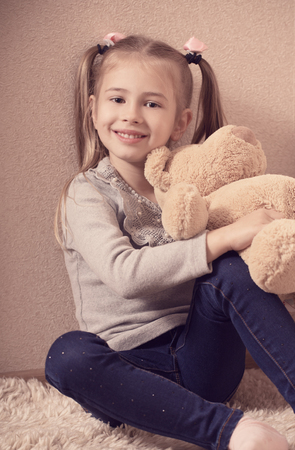 Cute little girl playing with bearの写真素材