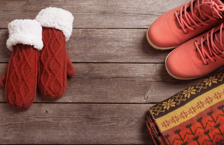 winter clothes and shoes on a wooden backgroundの写真素材