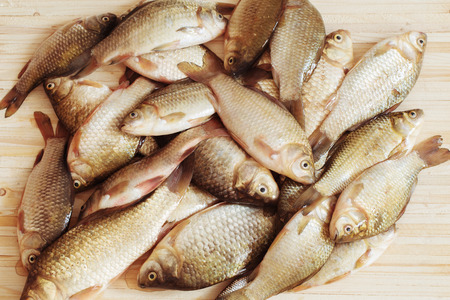 river raw fish on wooden tableの写真素材