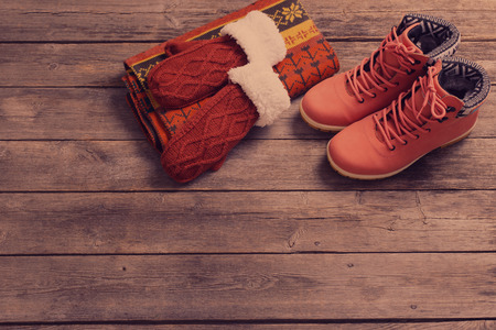 winter clothes and shoes on a wooden backgroundの写真素材