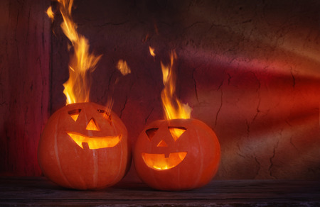 Halloween pumpkins on wooden table on dark backgroundの写真素材