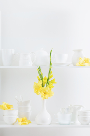 white dishvare with flowers on wooden shelfの写真素材