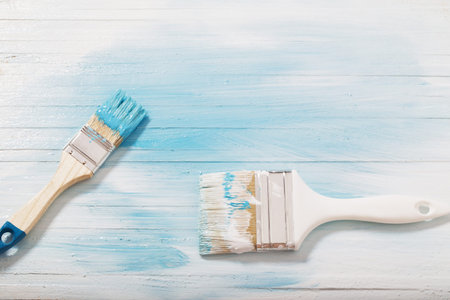 brush with paint on wooden background