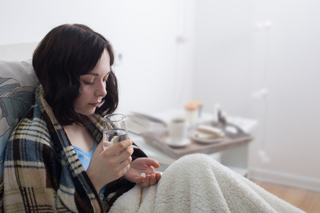 sick girl in bedの写真素材