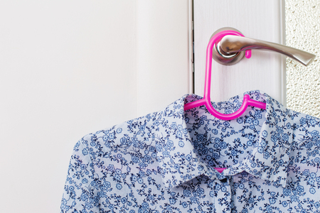 blouse on a hanger on the door handleの写真素材