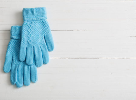 blue gloves on white wooden background