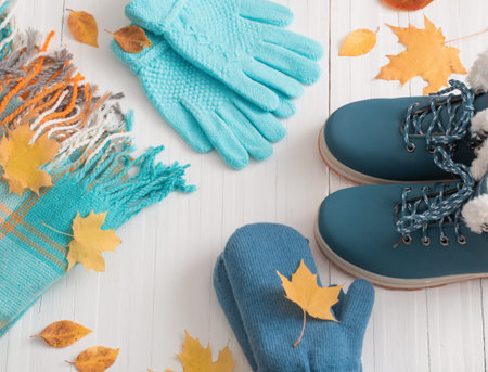 blue winter shoes and gloves on white wooden backgroundの写真素材